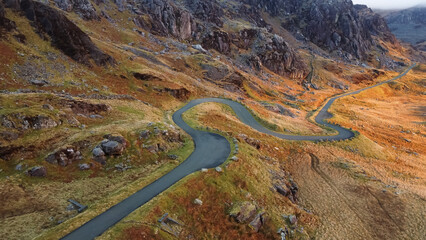 Aerial view of narrow winding road in mountainous area 