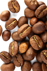 Color photo. Textured background. Coffee beans scattered on white background. Wallpaper. Cover. Postcard. Advertisement