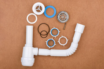 Completely disassembled complete sink drain assembly kit with flexible tube and accessories.