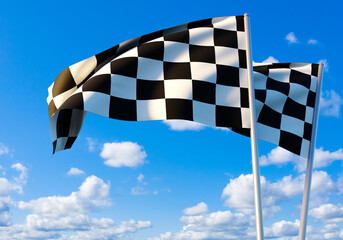 Two checkered racing flags wave under a bright blue sky with scattered clouds, marking the symbolic...