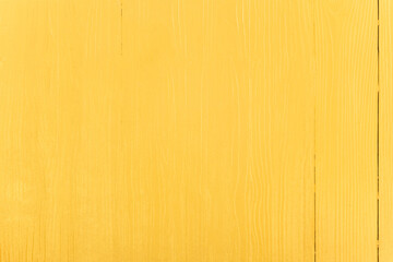 Naklejka premium Yellow painted vertical planks background.