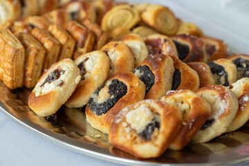 A plate of Moravian cakes. Traditional pastry with a filling of cottage cheese, poppy seeds, plum jam and cottage cheese. The pastry has a golden crust, pliable dough and sprinkled with breadcrumbs.
