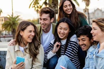 Happy group of young student people using cellphones at city street, connected in social media networks