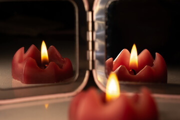 red candle with soft lighting with mirror