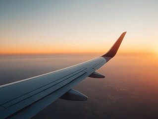 Fototapeta premium Aerial view of an airplane flying toward a glowing sunrise, with the earth s curve visible