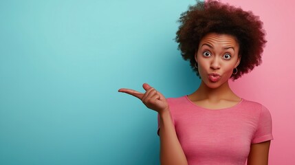 A casual woman with afro hair playfully poses pointing left against a pink and blue background