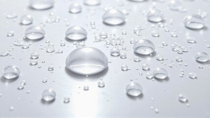 Macro Close-up of Transparent Water Droplets on a Smooth White Surface, Capturing Purity and Freshness
