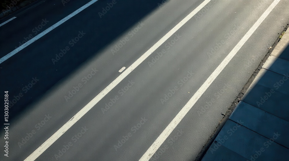 Fototapete asphalt road surface with parallel white lines and shadow cast by overhead structure