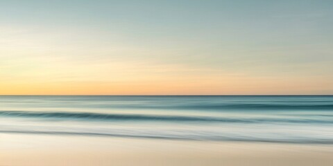 Obraz premium blurred seascape photograph of the ocean and beach, with the sky showing through in shades of blue