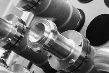A row of metal pipes with a silver finish. The pipes are connected to each other and appear to be...