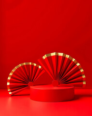 two red hand fans with gold accents displayed on a red cylindrical platform