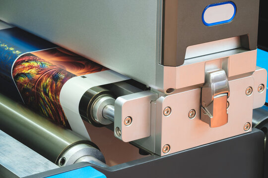 A machine is printing a colorful image on a piece of paper.  machine is using a special type of ink to create the image