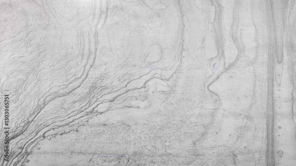 Poster A grey and white wall with a pattern that resembles a wave. The wall appears to be made of concrete and has a textured surface