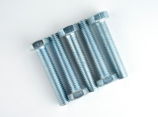 set of metallic bolts aligned on a white surface