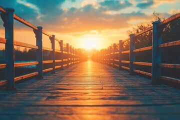 Obraz premium Beautiful sunset viewed from a wooden walkway leading into the horizon over water