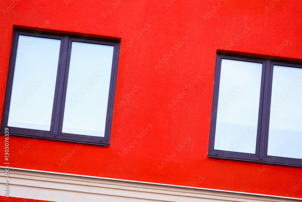 Aufkleber A small red building with two windows and a clock on the front, suitable for use in illustrations about time or architecture.