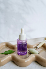 Bakuchiol face serum in a glass bottle on shadows background 