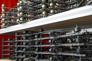 A stack of assembled FPV drone bodies with flight controllers, engines, and frontal cameras, each...