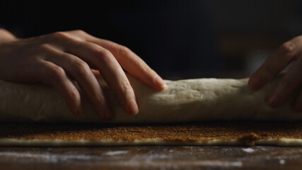 Cinnamon Roll Making: Rolling up the Dough into a Log.