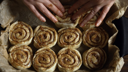 Placing cinnamon rolls in the baking pan.