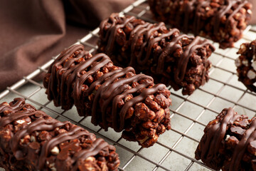 Delicious chocolate puffed rice bars on gray table, closeup