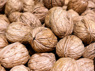 Raw Walnuts with shells background 