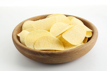 Tasty potato chips in bowl on white background, closeup