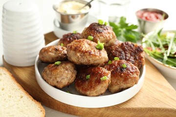 Delicious patties with green served on table, closeup