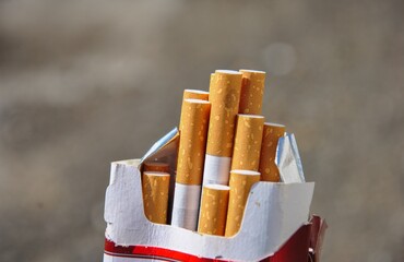 open pack of cigarettes on blurred background