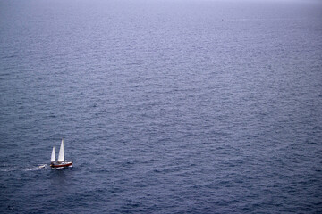 Fototapeta premium sailing boat on the sea off Capo Caccia. Alghero, Sardinia. Italy