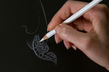 Jewelry Designer Jobs Jewelry designer develops sketches of jewelry. Process of drawing jewelry on black background. Design studio. Creative ideas.