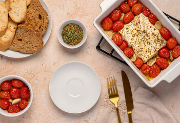 Food photography of roasted feta cheese, tomatoes and garlic with toasted bread, thyme, herbs, healthy  food, Mediterranean cuisine