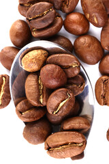 Coffee beans on a chrome plated spoon. Macrophotograph. Morning mood. First person image. Textured background. Postcard. Cover. Wallpaper. Picture