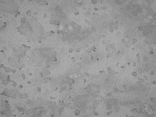 A worn concrete surface with water marks and uneven texture.