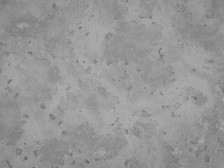 Abstract gray concrete with varied spots and stains creating a textured look.