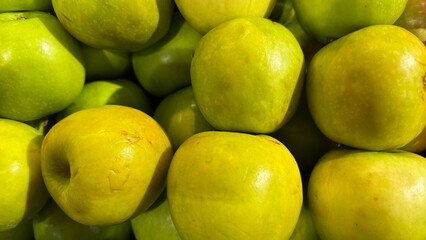 Fresh Green Apples Stacked in a Market Showcasing Their Vibrant Color and Natural Sheen