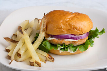 salmon burgeron a brioche bun with fries