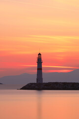 Seascape at sunshine. Lighthouse and sailings on the coast. Seaside town of Turgutreis and spectacular sunshine
