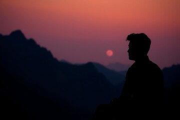 Warm and Soft Lighting with Subtle Darkness Highlighting a Man's Seated Silhouette in Vibrant Colors