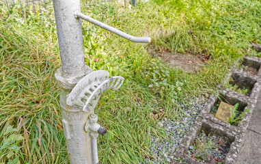 Vintage hose holder and a bracket in Grassy Area