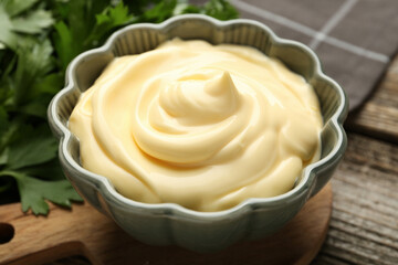 Delicious mayonnaise sauce in bowl on table, closeup