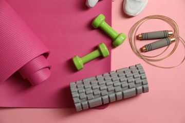 Different gym stuff on pink background, flat lay