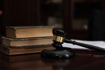 Judge workplace with gavel and books indoors