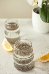 Chia water with lemon on white background - healthy drink to start the day, great for hydration, digestion and detox, shot in bright morning light