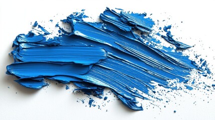 A bold blue paint is spread across a clean white surface, showcasing the texture and thickness of the paint. The activity suggests an artist at work, bringing color to life