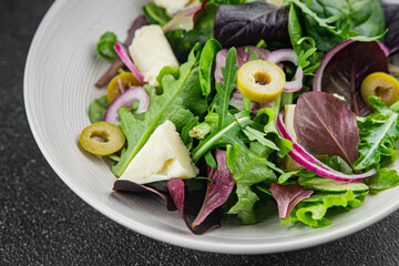 Salad with olives, cheese and green leaves fresh delicious gourmet food background on the table rustic food top view copy space keto and paleo diet vegetarian  food