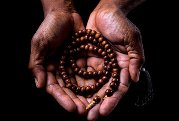 Hands holding prayer beads