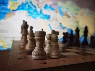 Geopolitical Strategy Concept. Chess, Strategy game with pieces on chessboard and world map in background