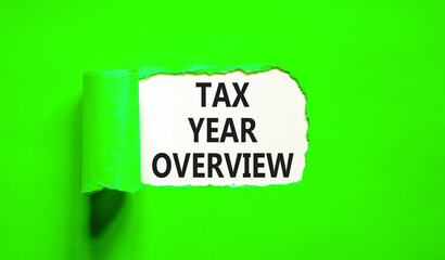 Tax year overview symbol. Concept words Tax year overview on beautiful white paper. Beautiful green table green background. Business tax year overview concept. Copy space.
