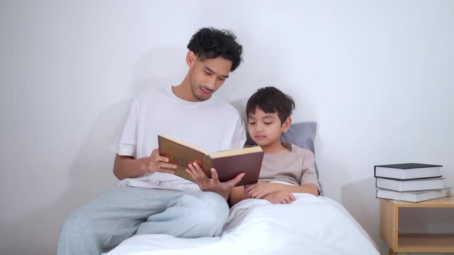 Asian man let his son learn about the holy koran.